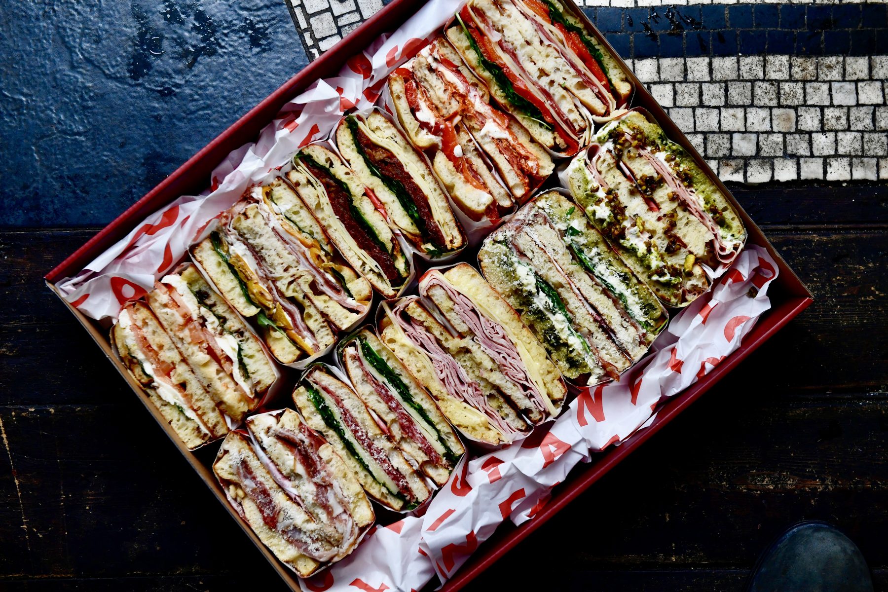 A generous Santo Cielo SC Platter of mixed Italian schiacciata sandwiches, viewed from above