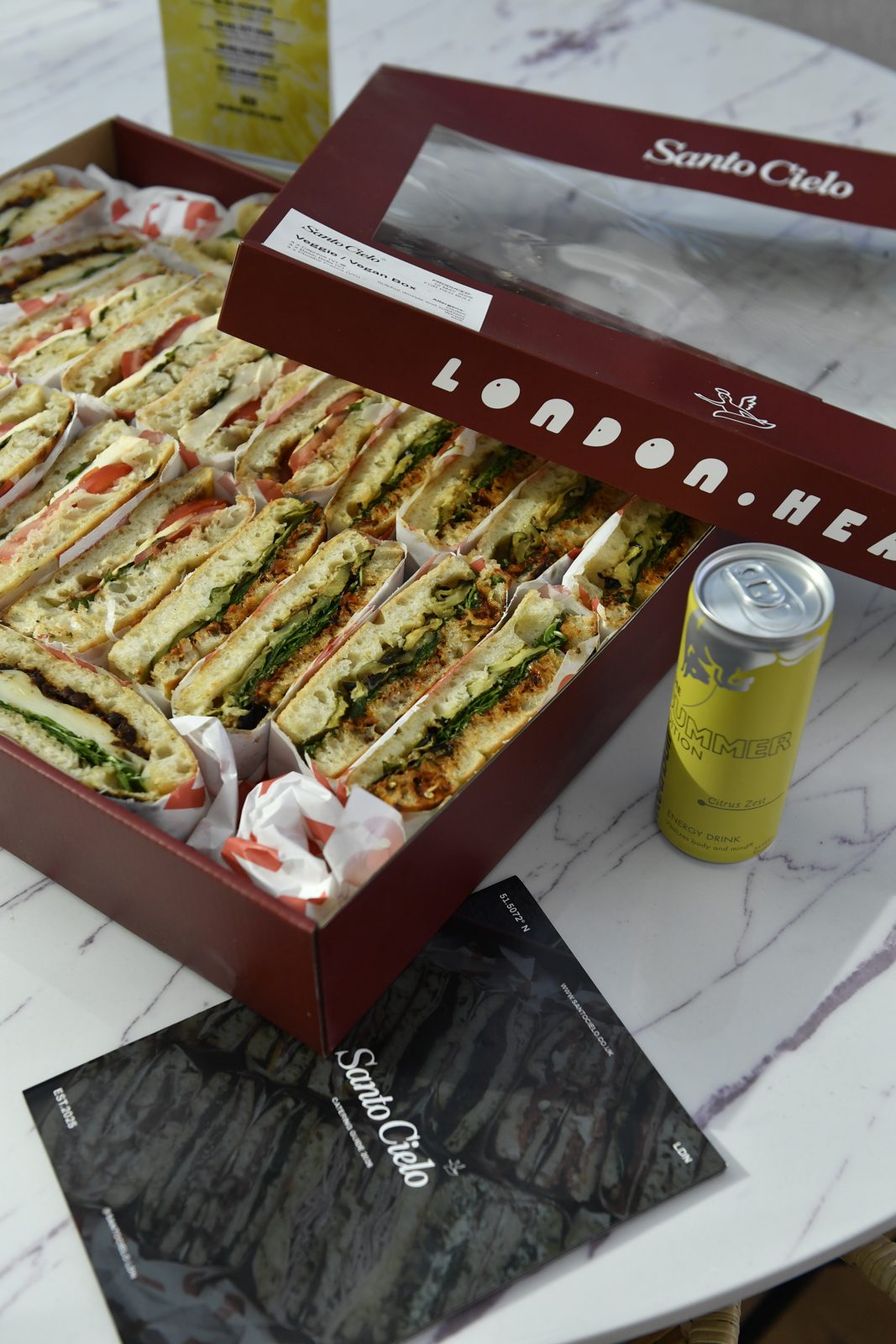 Santo Cielo veggie and vegan platter box with a Red Bull Summer Edition can at the party